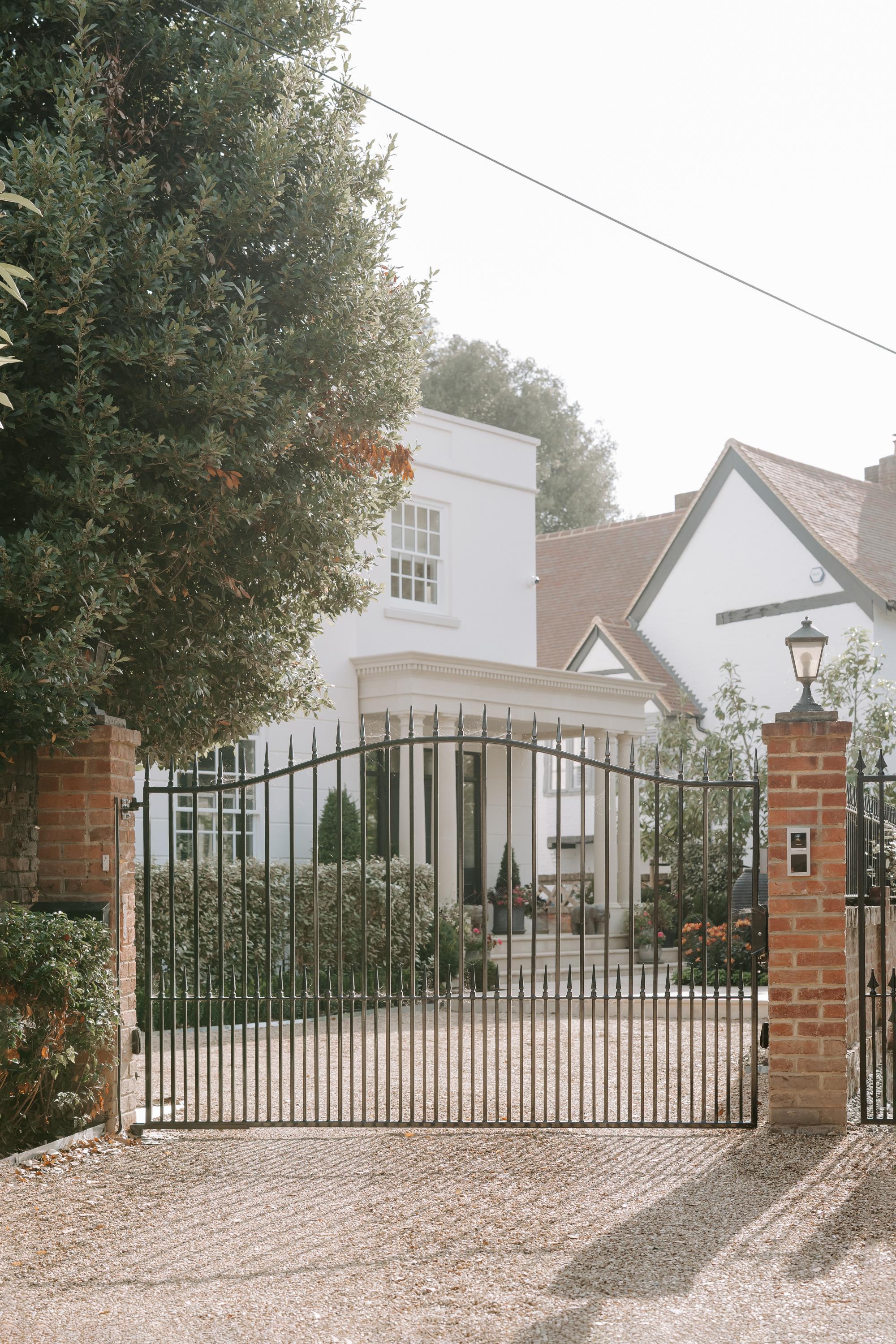 metal black gates and white house